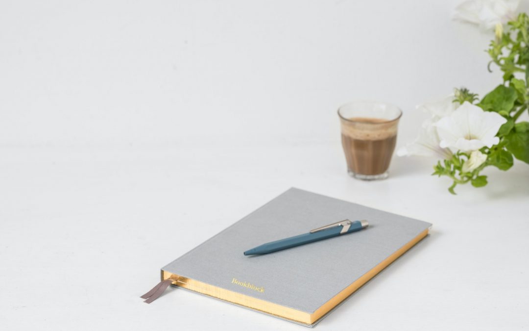 Notebook and pen to represent gratitude journaling and other mental exercises.