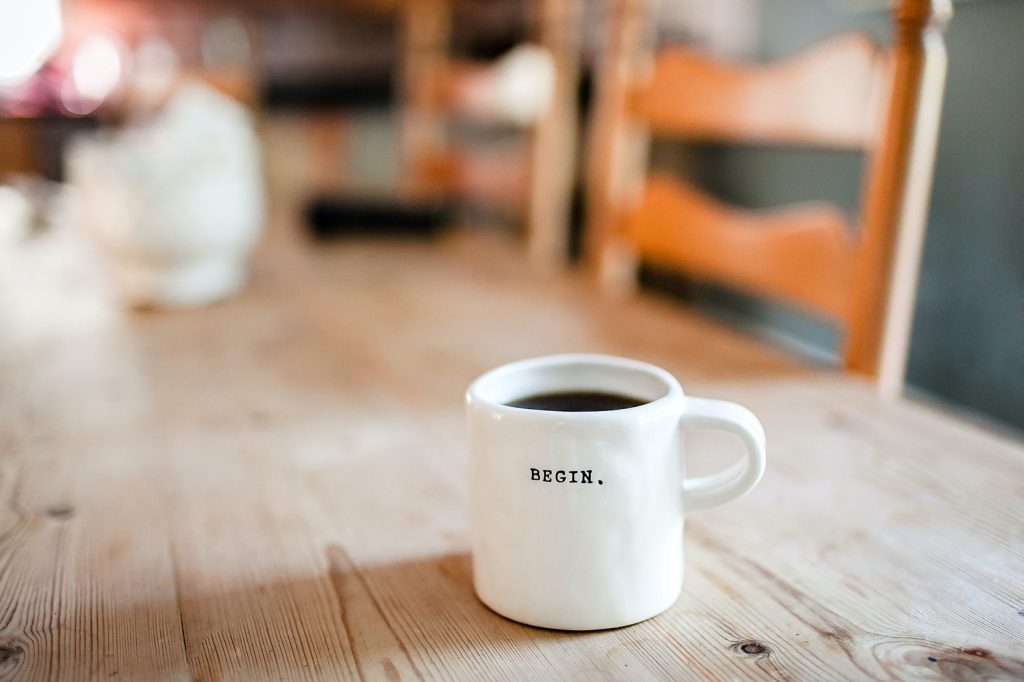 Coffee mug sitting on table to represent What happens in your first therapy session.