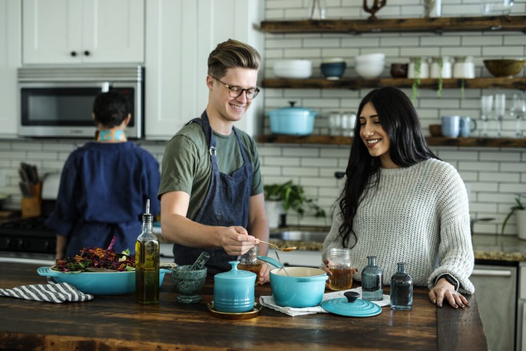 Two people in the kitchen cooking for the holidays.